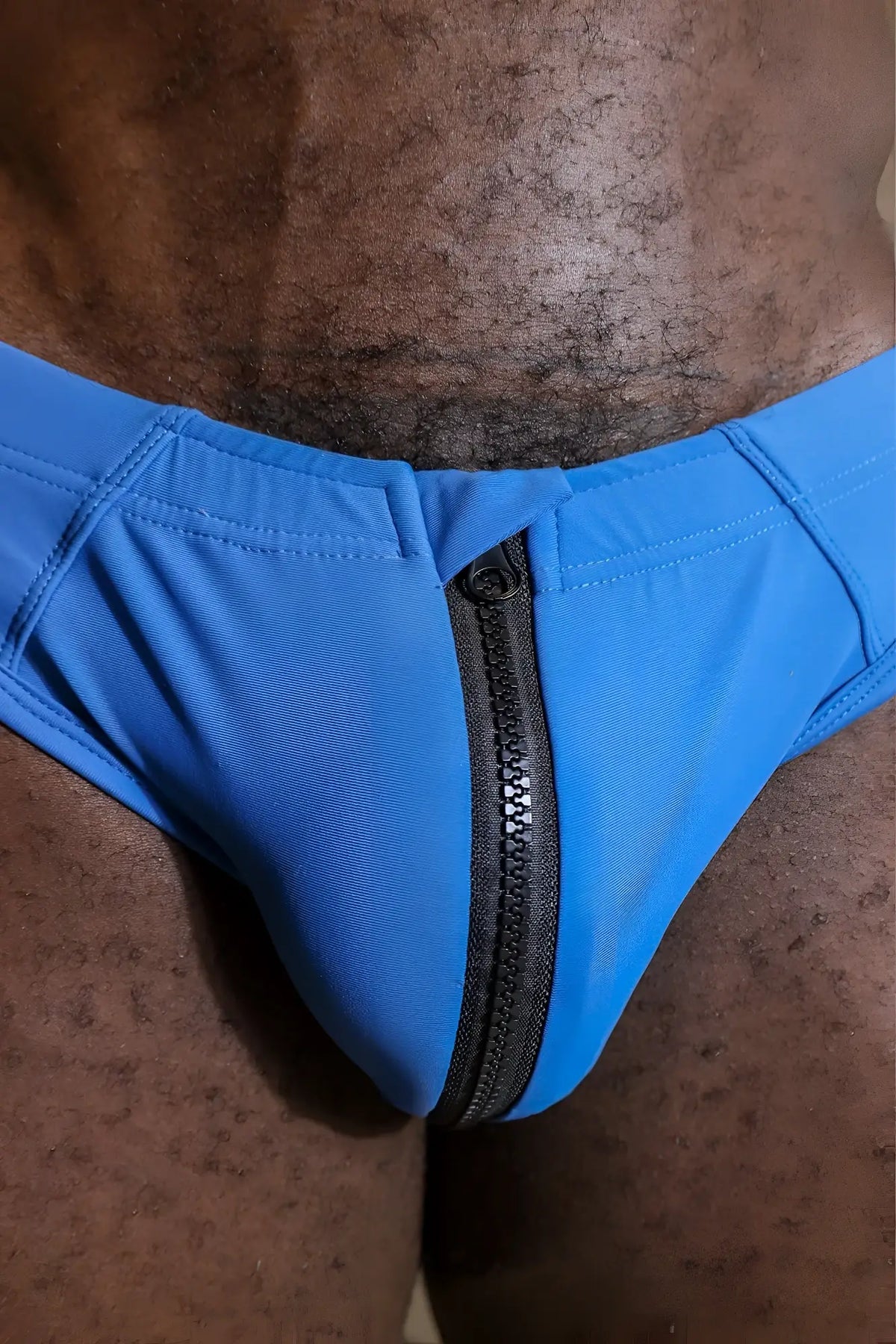 Bright blue unzip me swim briefs featuring a black zipper down the center for easy wear and quick drying