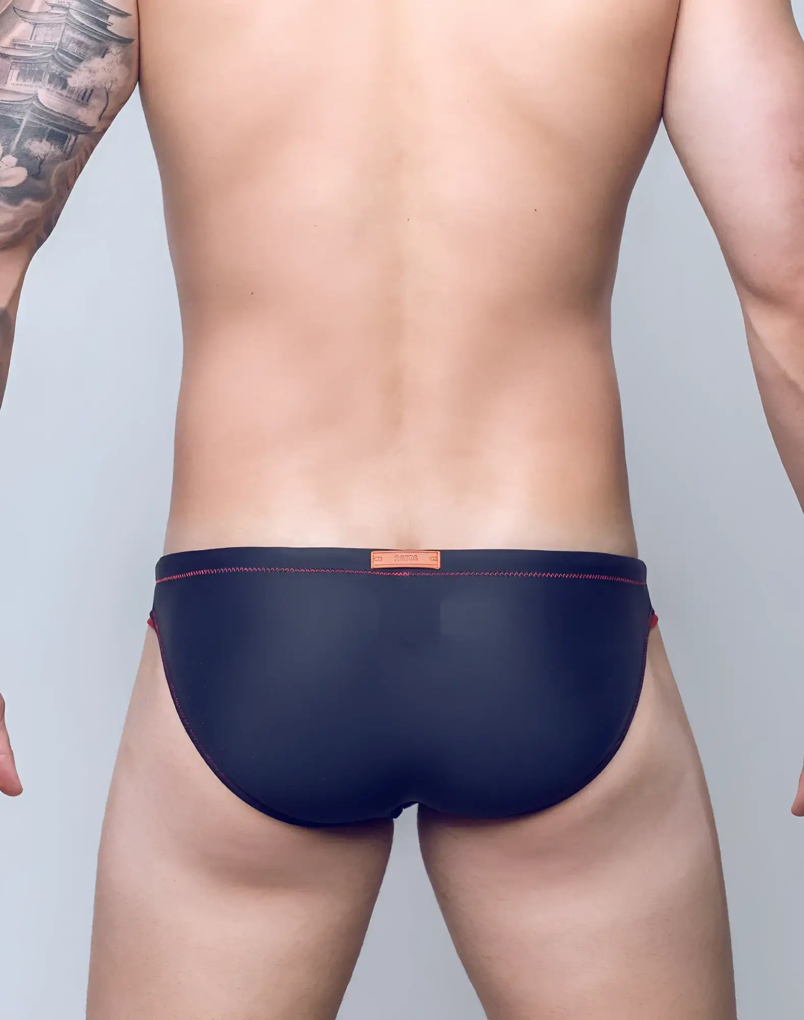Navy blue V22 rapid swim briefs with red stitching and an orange brand tag at the waistband for quick drying