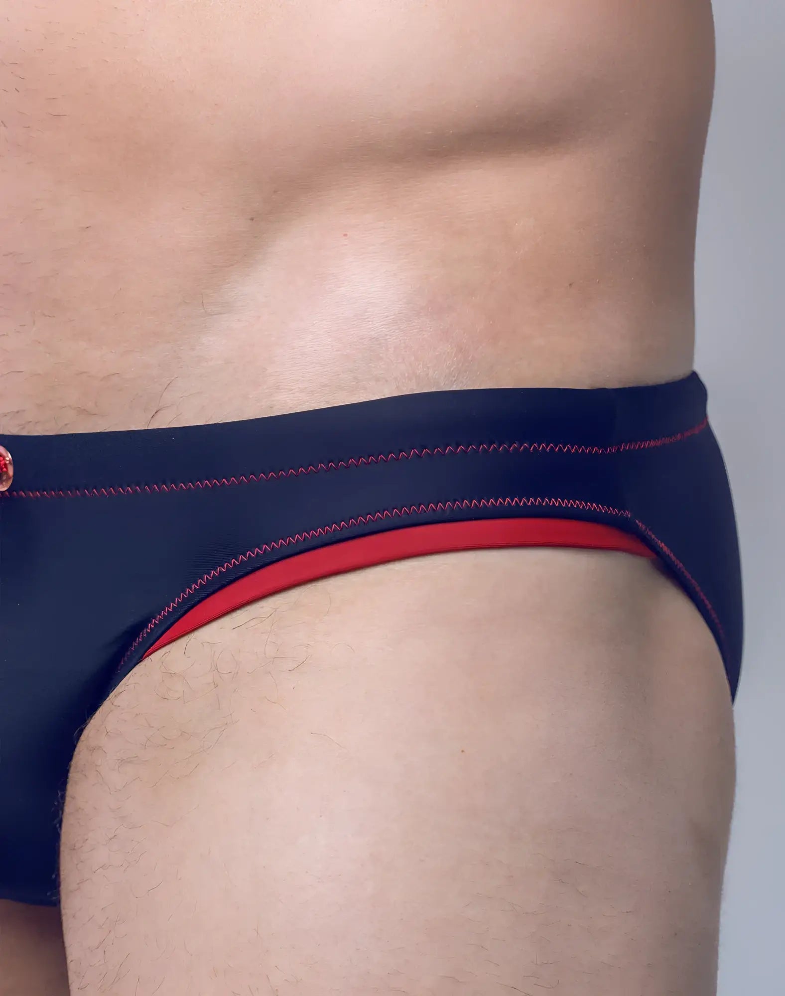 Navy blue v22 rapid swim brief with red trim and contrasting stitching designed for quick drying and swim performance