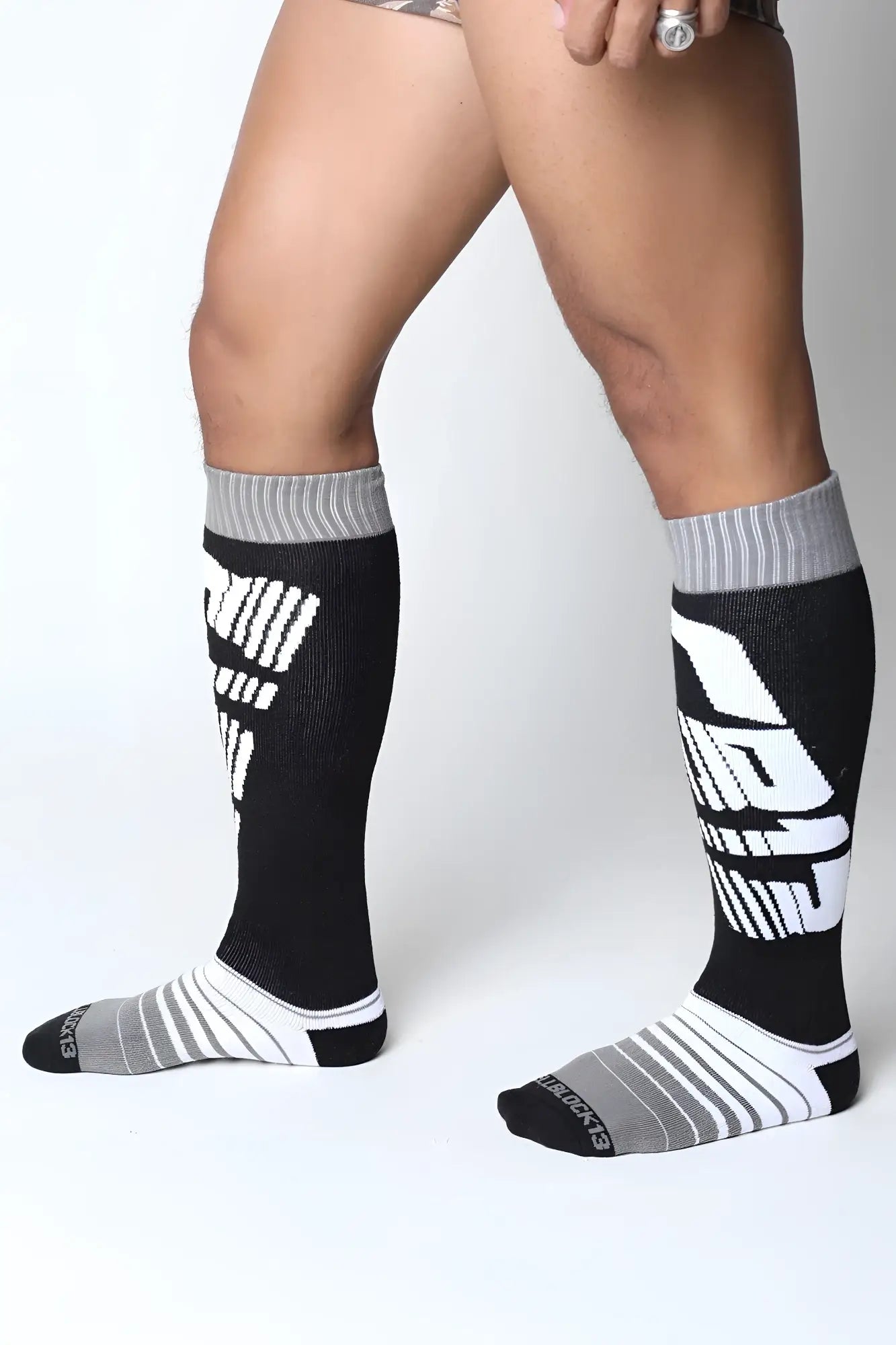Black and gray velocity 2.0 knee high athletic socks with bold white graphic lettering for performance use
