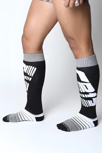 Black and gray velocity 2.0 knee high athletic socks with bold white graphic lettering for performance use