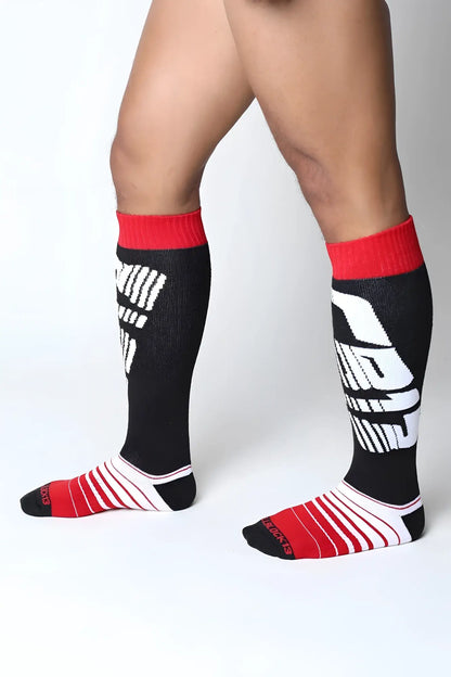 Velocity 2.0 knee high athletic socks in black and red with bold white graphic design for sports use