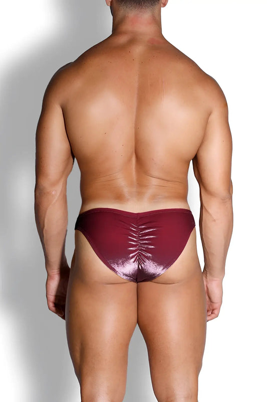 A shiny metallic burgundy velvety scrunch-butt bikini brief showing the ruched back design