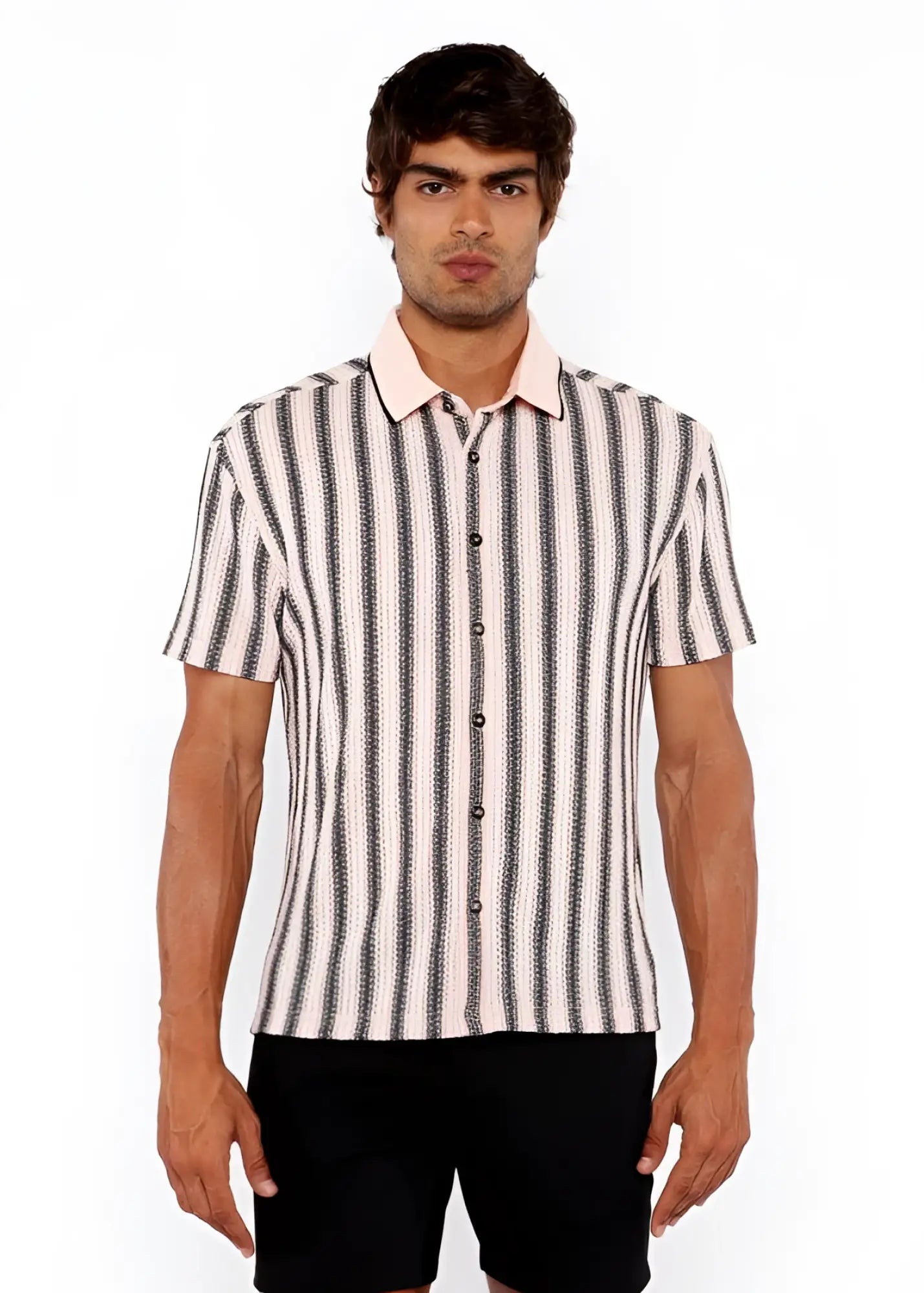 A man wearing a vertical stripe open stretch knit shirt with rib collar in black and off-white short sleeves