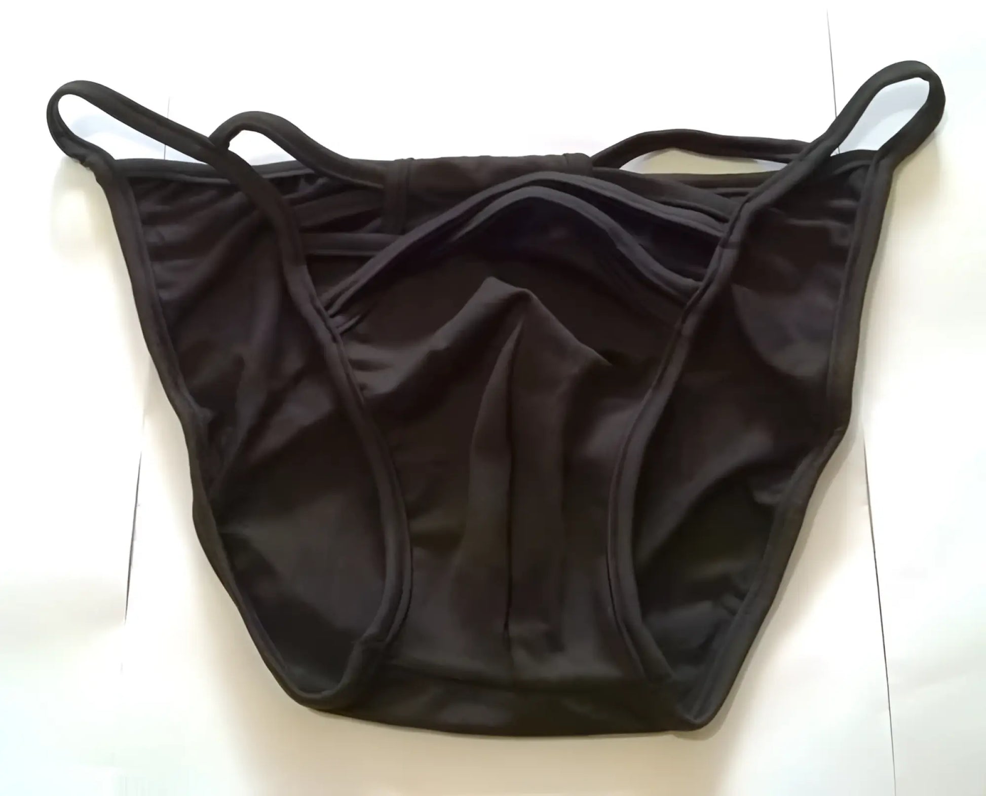 Black smooth-textured fabric strapwork bikini swimwear briefs with thin elastic straps size s back view