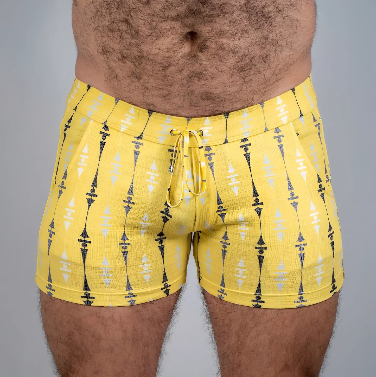 Bright yellow wallpaper print linen texture shorts with black and white geometric pattern and matching drawstring waistband