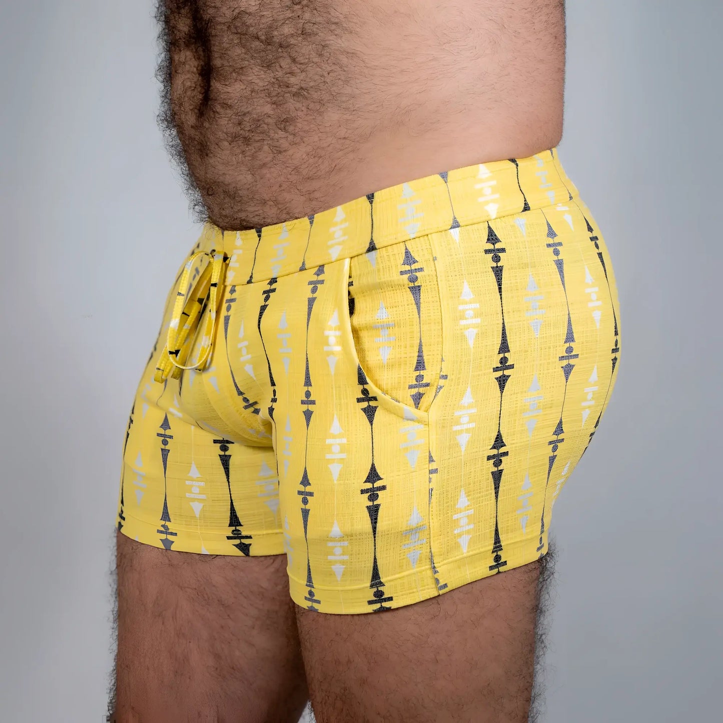 Bright yellow wallpaper print linen texture shorts with bold black and white geometric pattern and elastic waistband