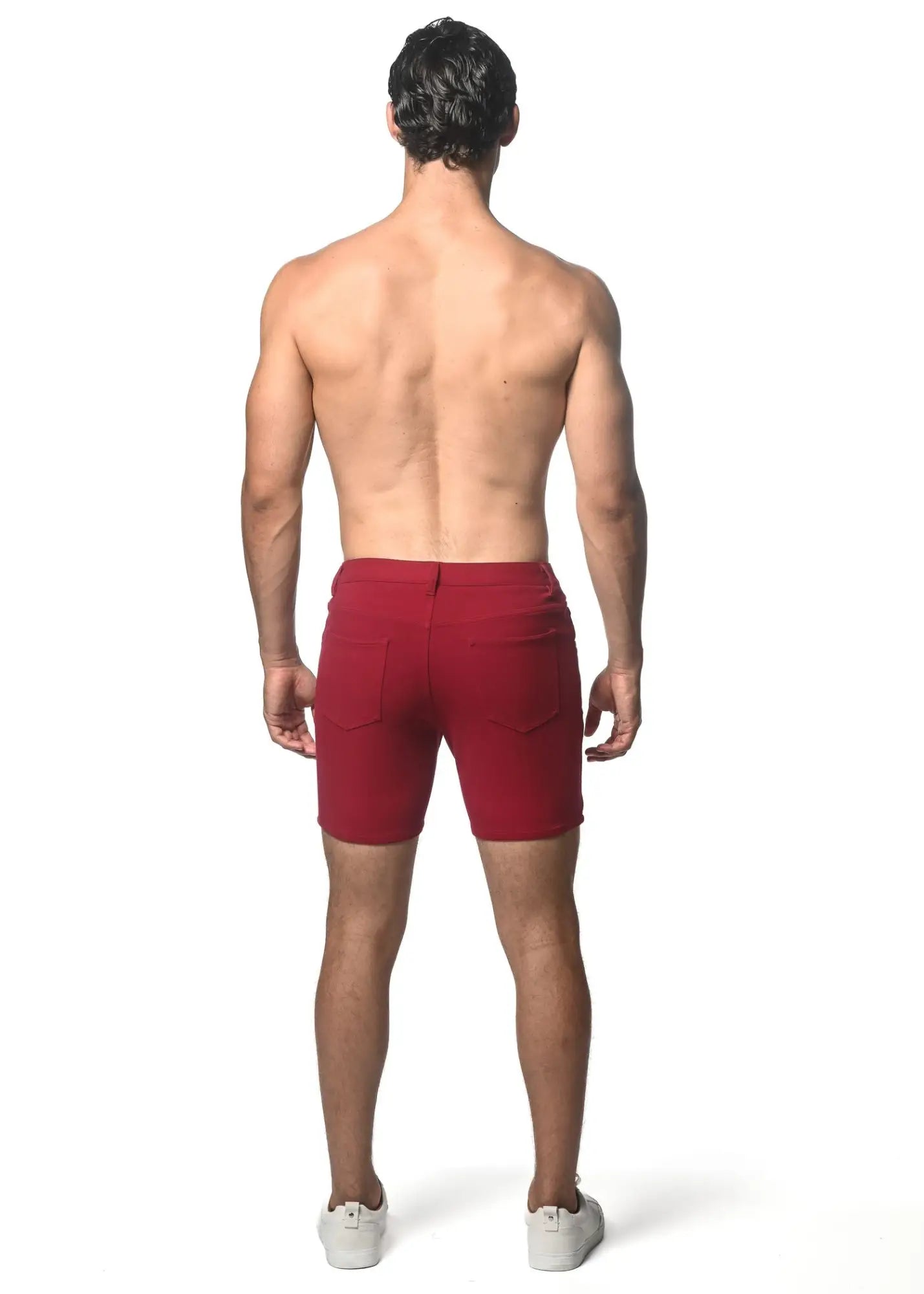 Red washed denim stretch knit shorts with tailored fit and two rear pockets shown from the back side