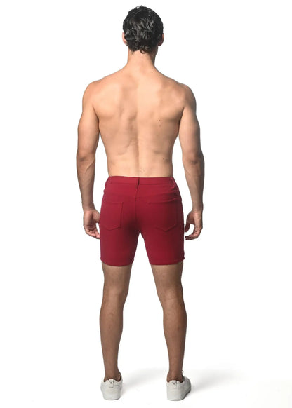 Red washed denim stretch knit shorts with tailored fit and two rear pockets shown from the back side