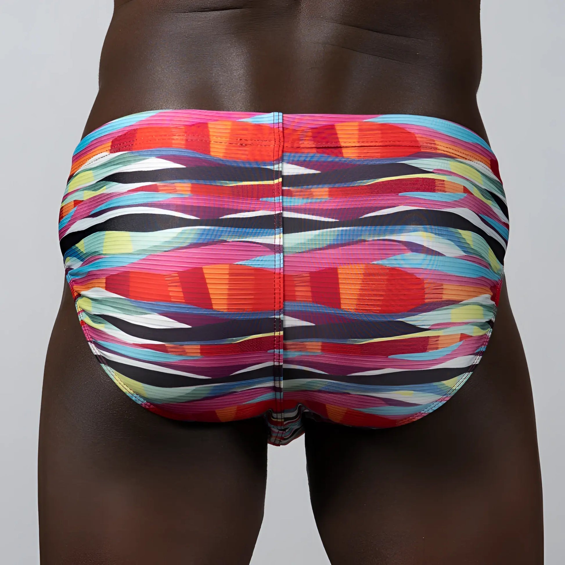 Waves print brief swim trunks with vibrant multicolored abstract stripes in pink orange blue and black