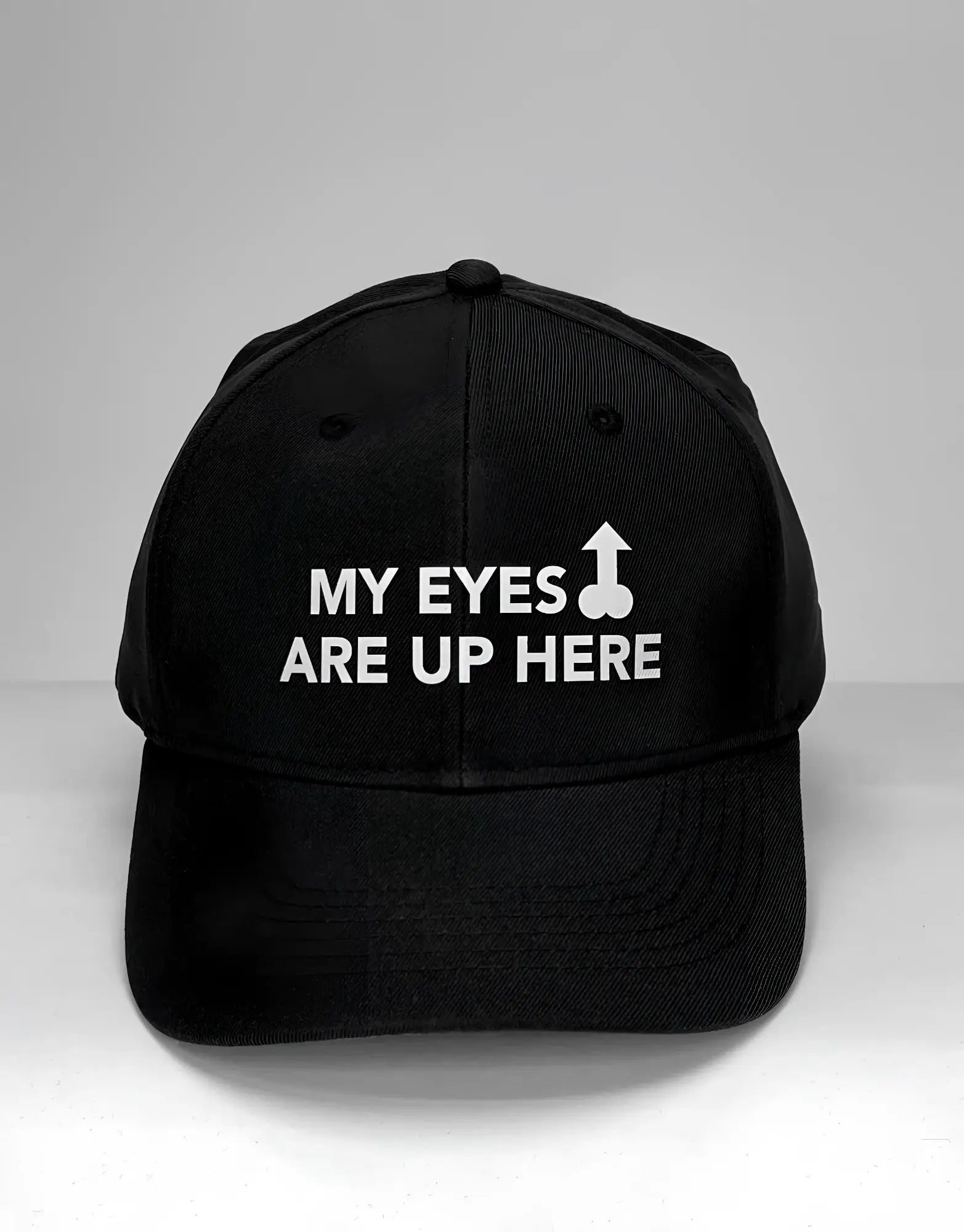 Wildmant ball cap black with white embroidered text my eyes are up here and a stylized upward arrow symbol