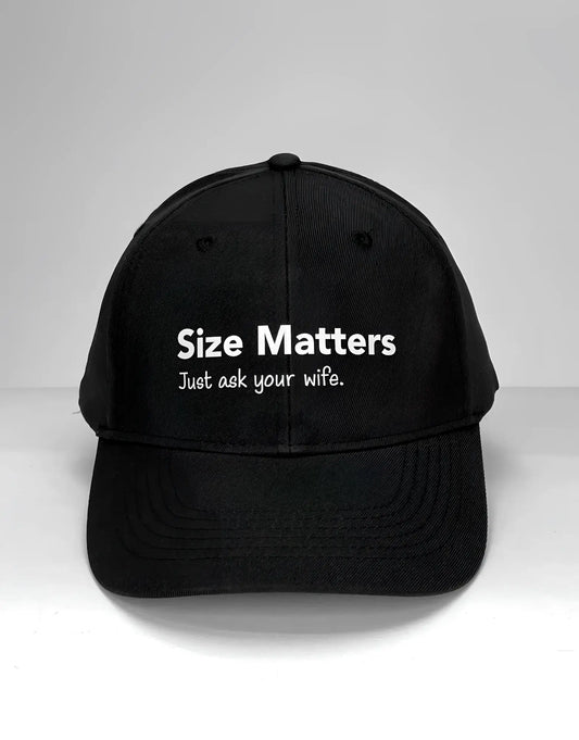 Black baseball cap with white text that reads "Size Matters" and "Just ask your wife." centered on the front.