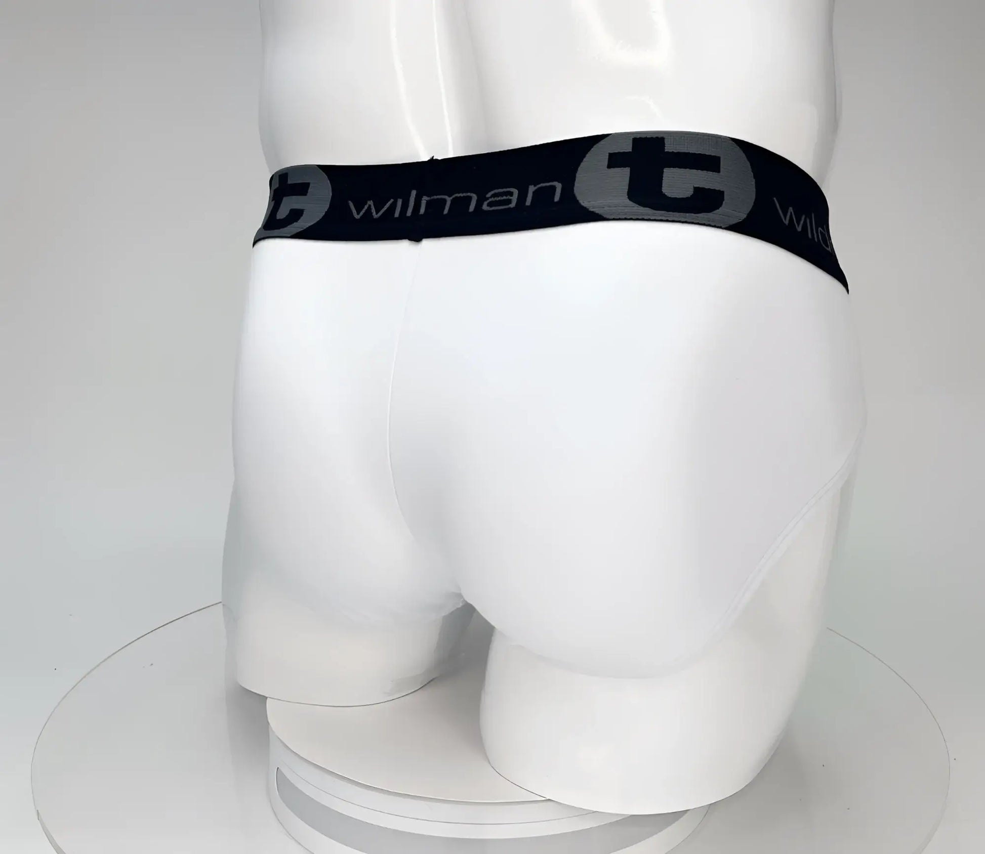 White cotton WildmanT big boy pouch briefs with black elastic waistband featuring wilman brand name and logo