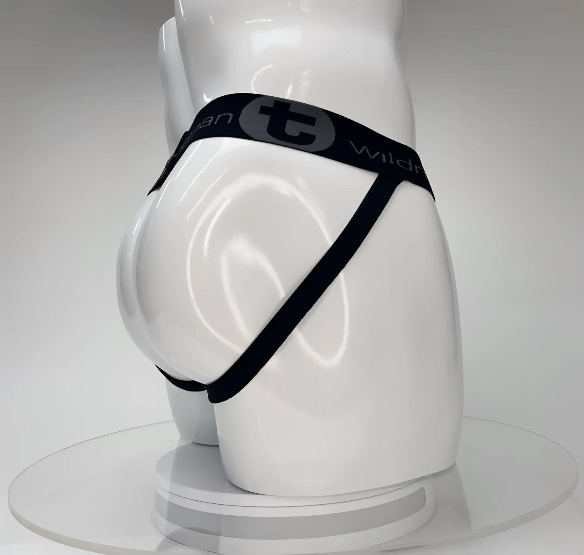 Wildmant big boy pouch jockstrap white featuring a black elastic waistband with gray wild logo worn by white mannequin