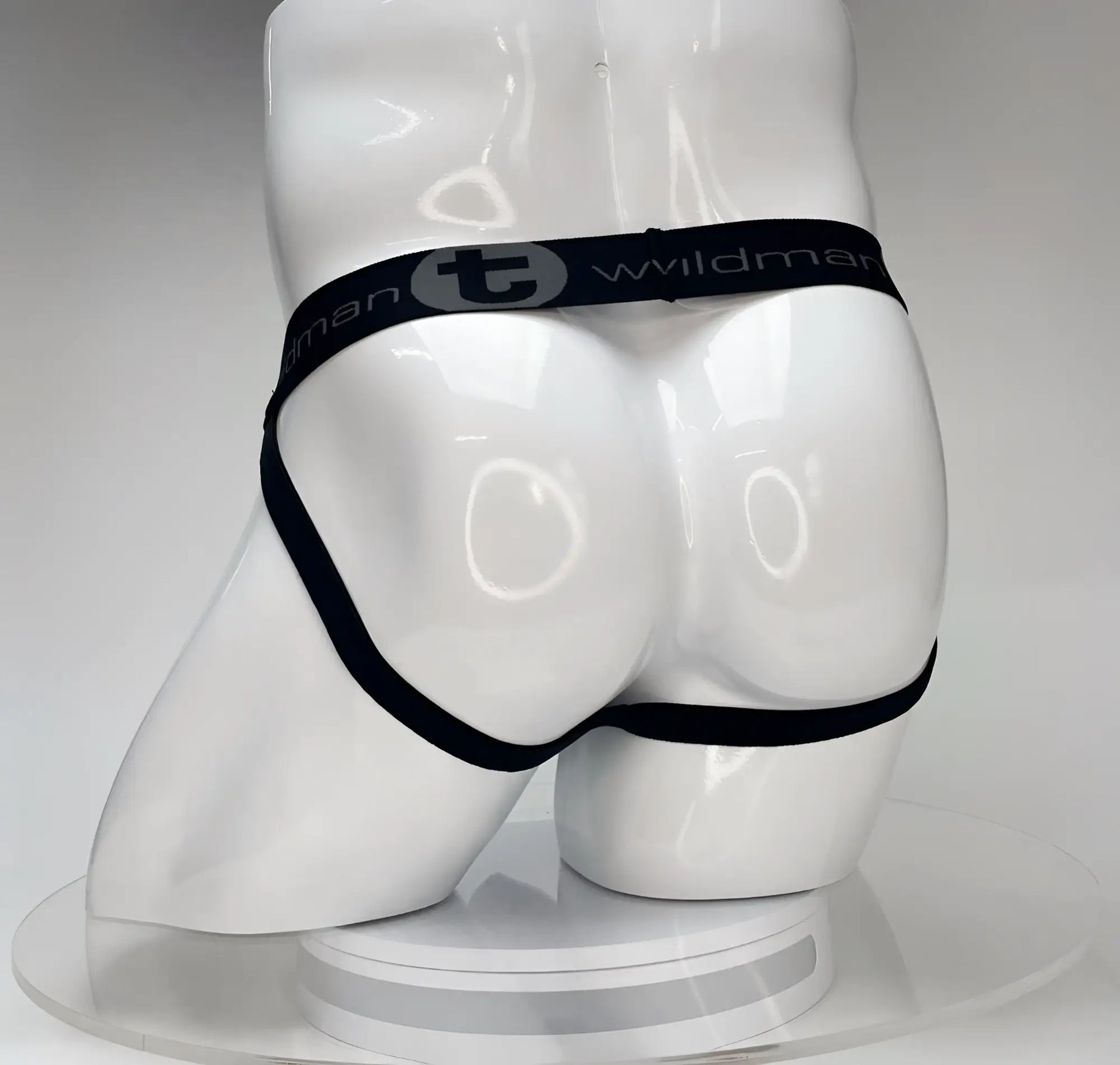 Black elastic waistband briefs with wildman branding on white mannequin for wildmant big boy pouch jockstrap white product