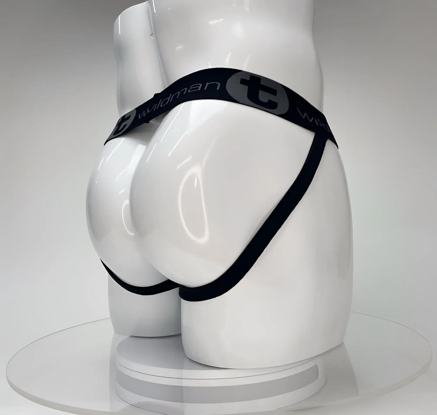 Black elastic waistband briefs with wildman branding displayed on white mannequin from wildmant big boy pouch jockstrap white