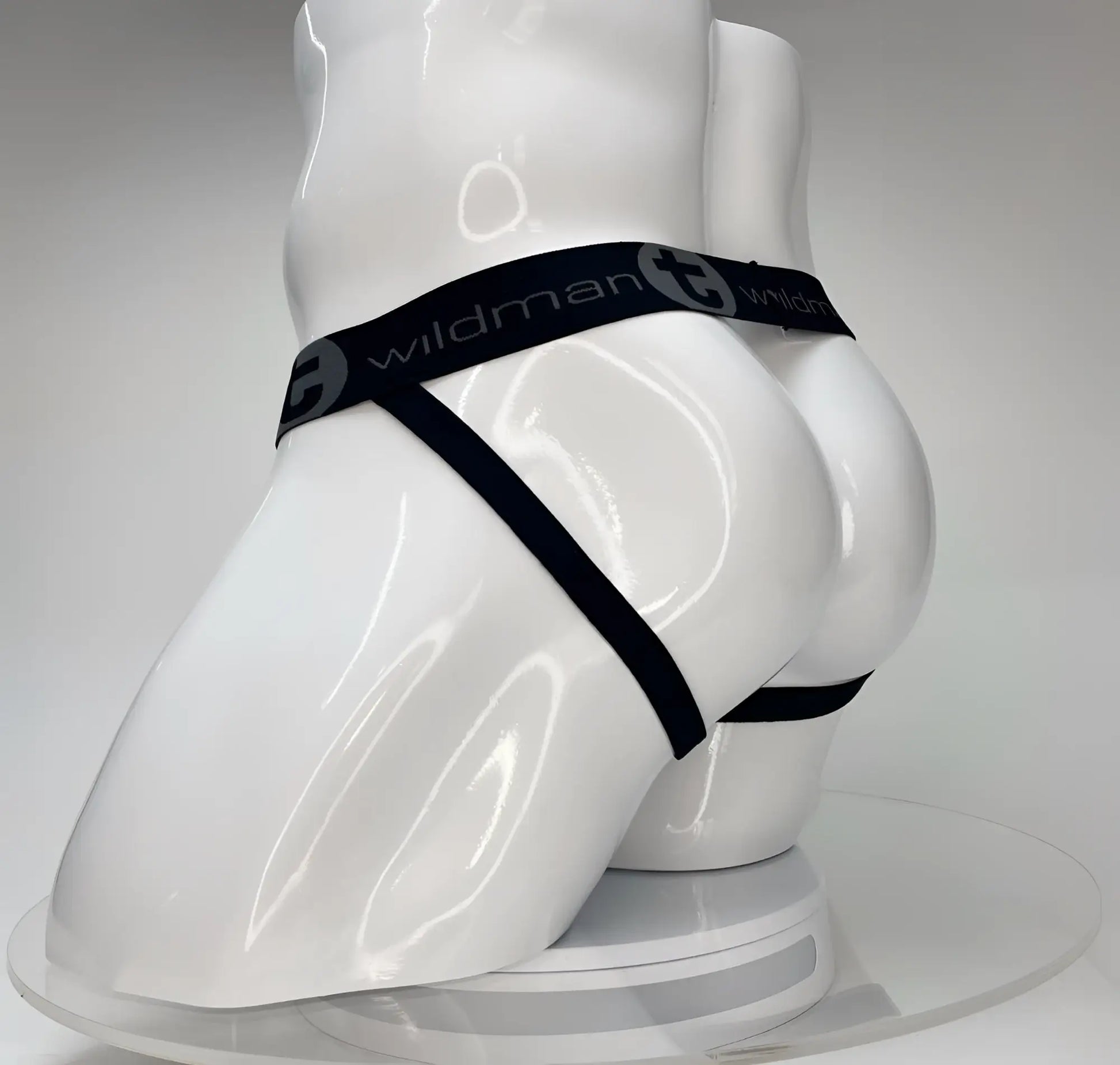 Black elastic waistband with wildman branding on white mannequin showing wildmant big boy pouch jockstrap white