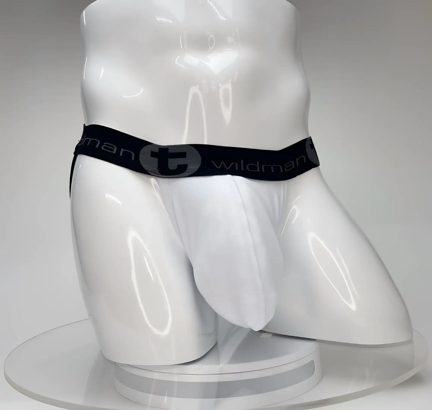 White wildmant big boy pouch jockstrap briefs with black elastic waistband featuring wildman logo and stylized t emblem