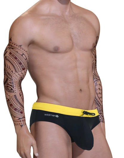 Yellow and black Big Boy pouch swim bikini with a front drawstring, worn by a muscular man with tribal arm tattoos.
