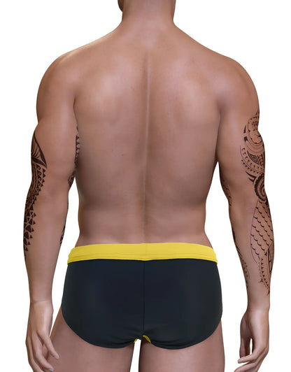 Back view of a muscular man with tribal arm tattoos wearing a black swim bikini with a yellow waistband.