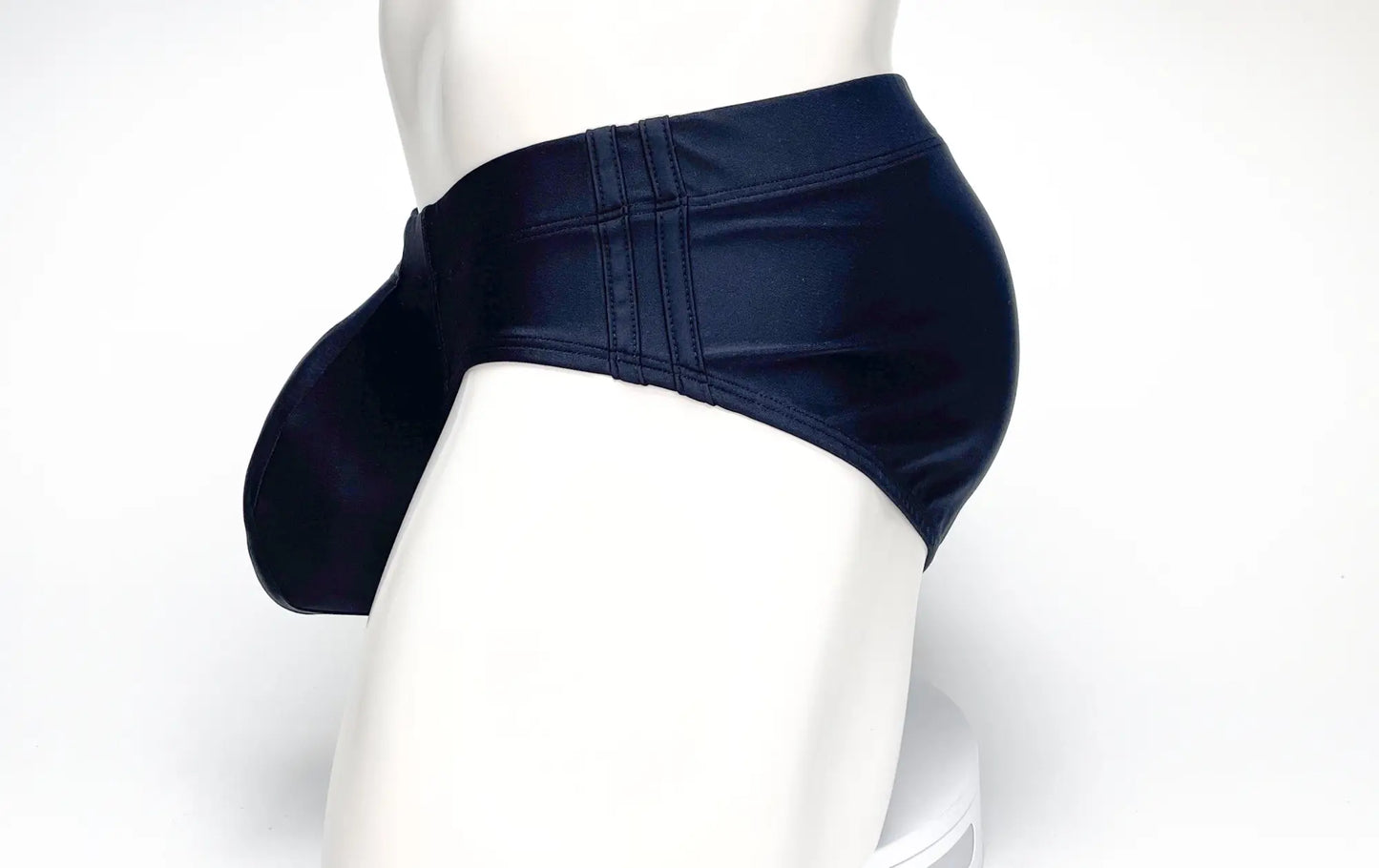 Wildmant big boy pouch swim brief in dark navy blue glossy faux leather with a prominent side pouch and stitched detailing