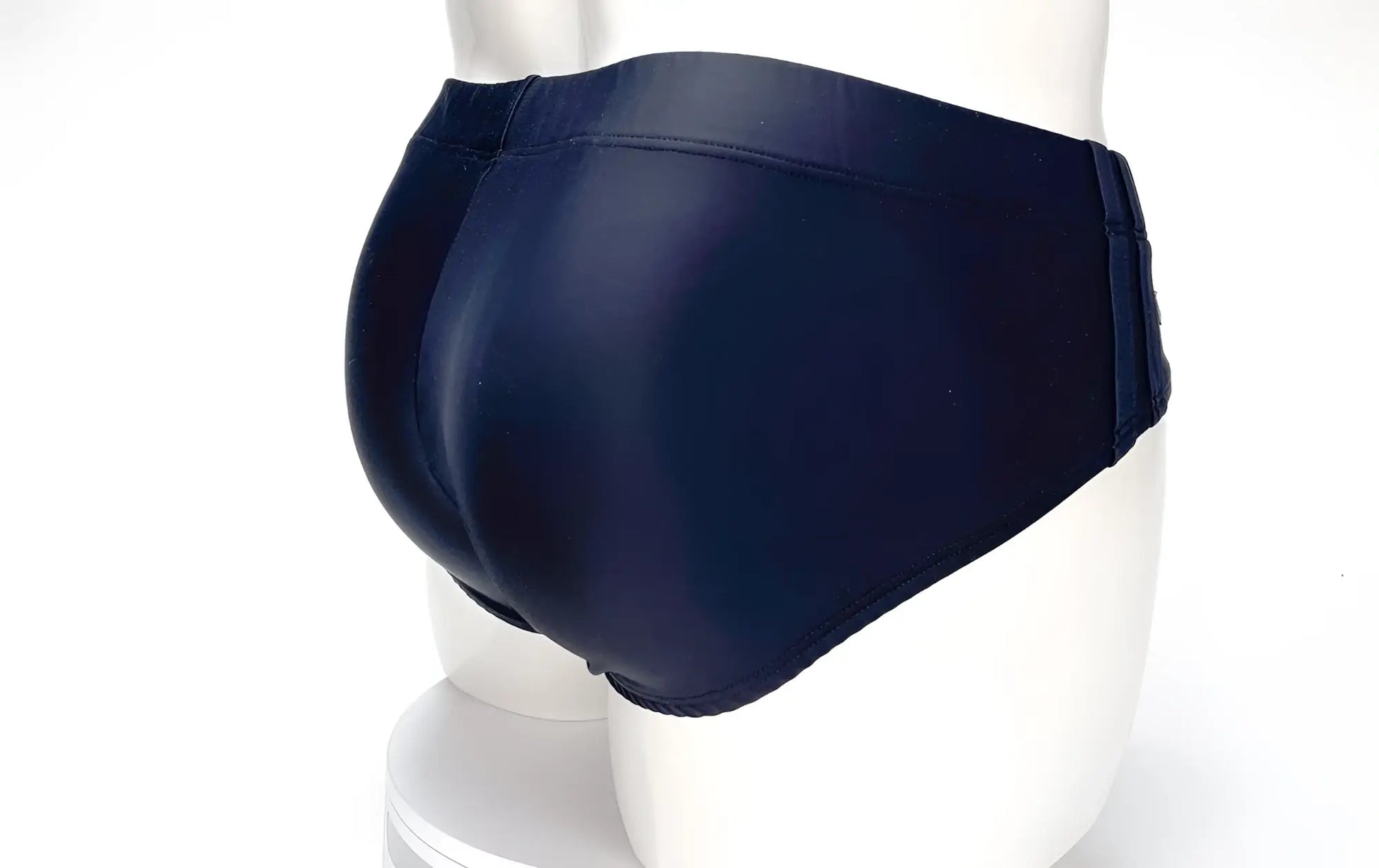 Rear view of WildmanT Big Boy black swim brief on a white mannequin, showing a smooth, full-coverage fit.