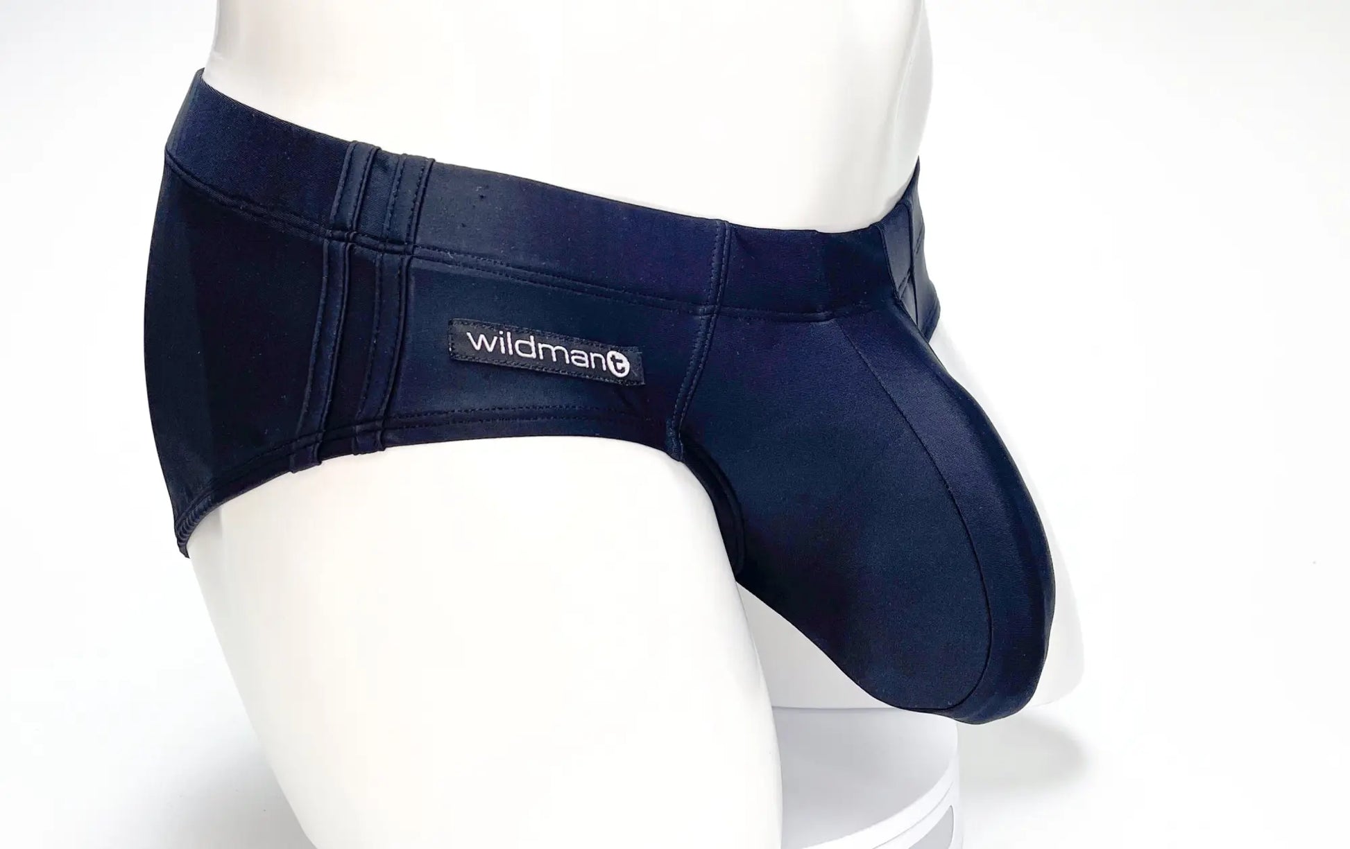 Navy blue WildmanT Big Boy Pouch swim briefs with stretch fabric and a branded patch on the waistband