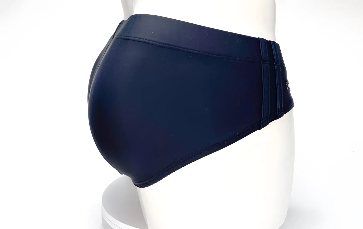 WildmanT Big Boy Pouch swim brief in black, shown from the side on a mannequin featuring a wide, contoured waistband.