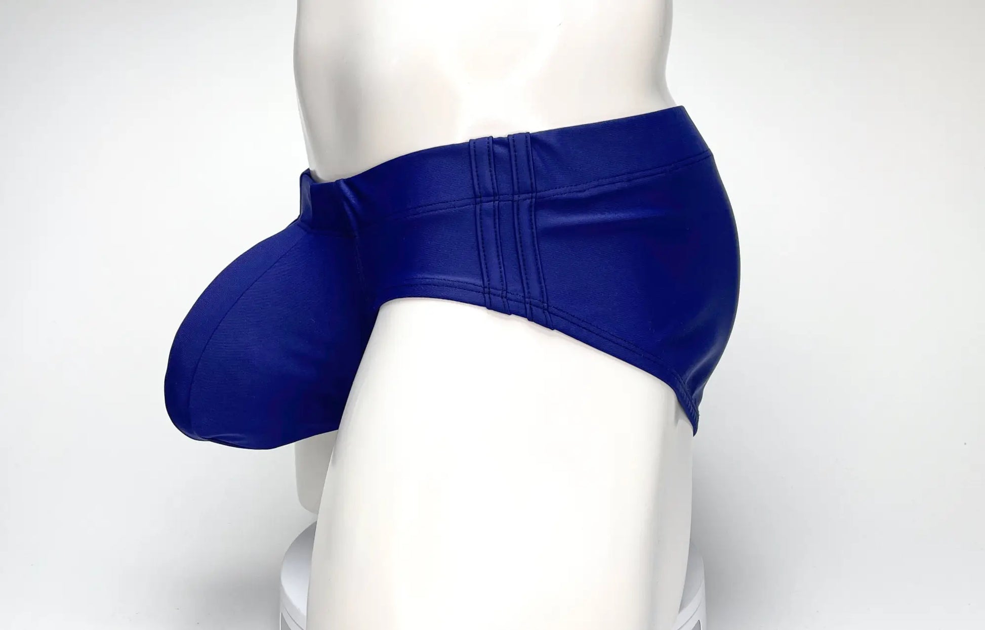 Wildmant big boy pouch swim brief navy made of blue faux leather with a prominent padded pouch for swimwear use