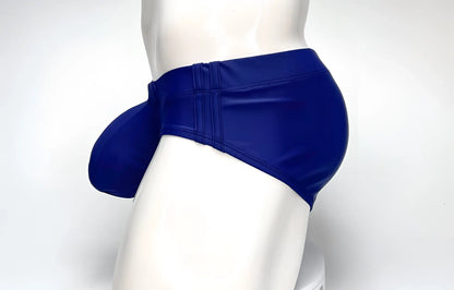 Side view of a navy WildmanT Big Boy Pouch swim brief on a mannequin, highlighting the prominent contoured front pouch.