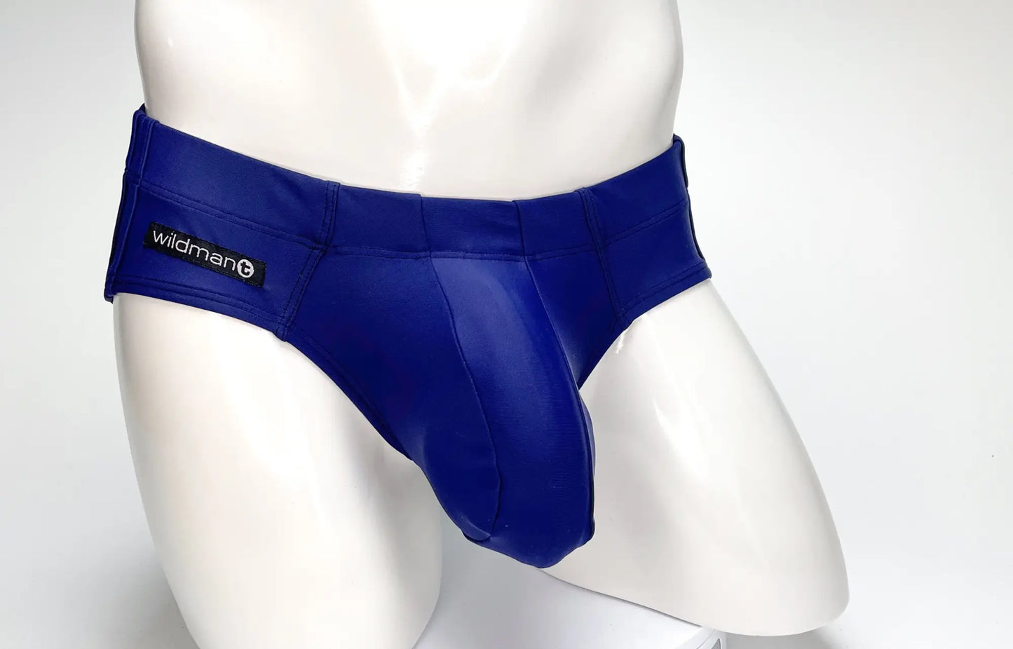 Royal blue glossy latex WildmanT Big Boy Pouch swim briefs with black Wildman brand label on the waistband