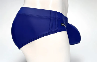 Navy WildmanT swim brief with a prominent, contoured big boy pouch and branded side label on a mannequin.