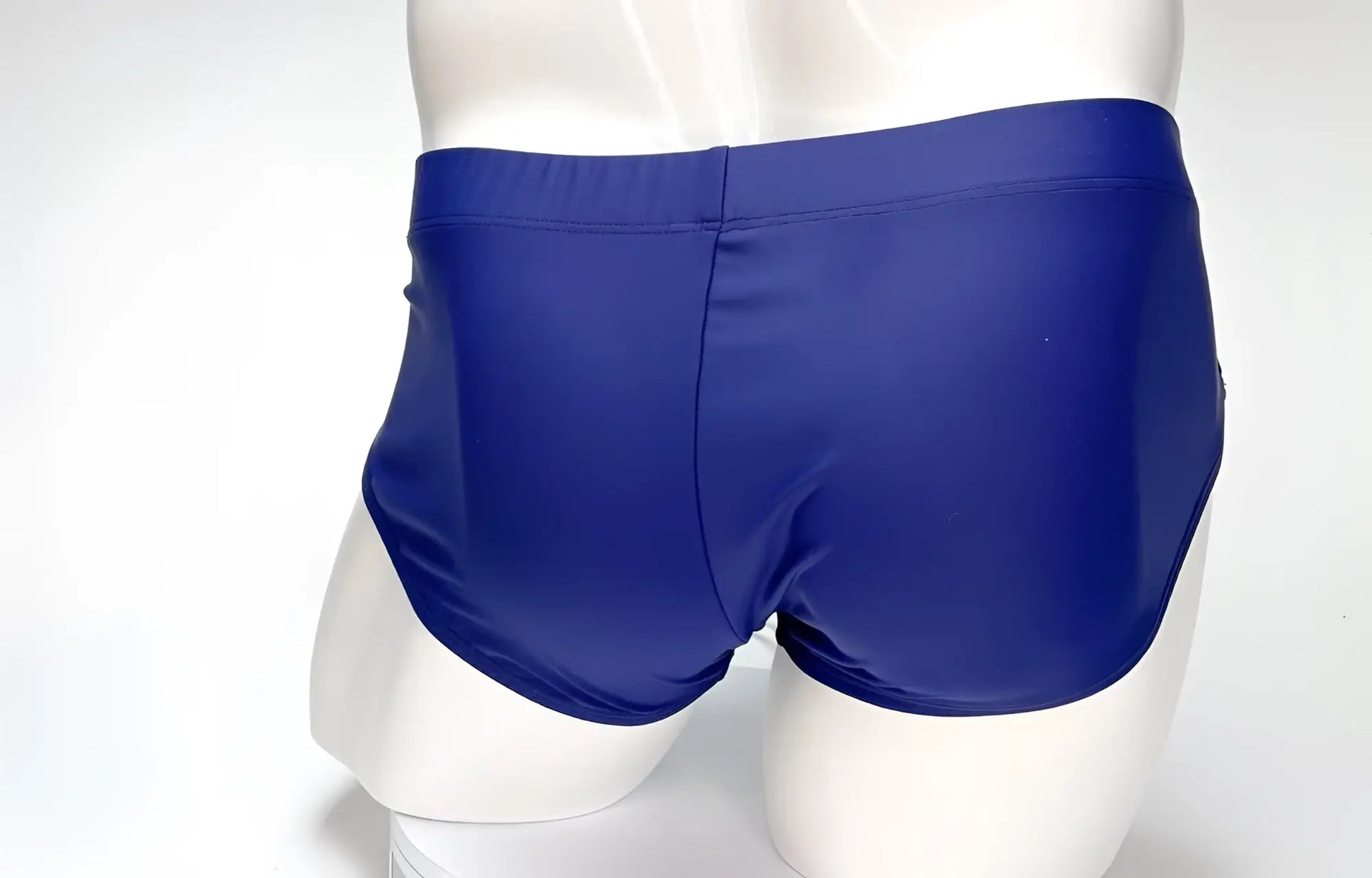 Back view of a WildmanT Big Boy navy blue swim brief on a white mannequin.
