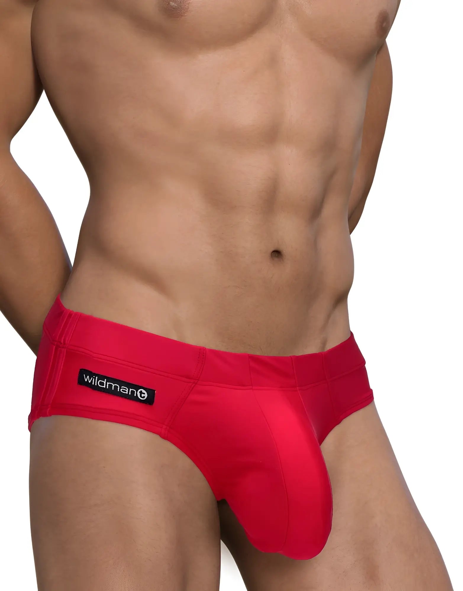 Bright red form-fitting men’s swim briefs with a black wildman brand label on the waistband for big boy pouch style