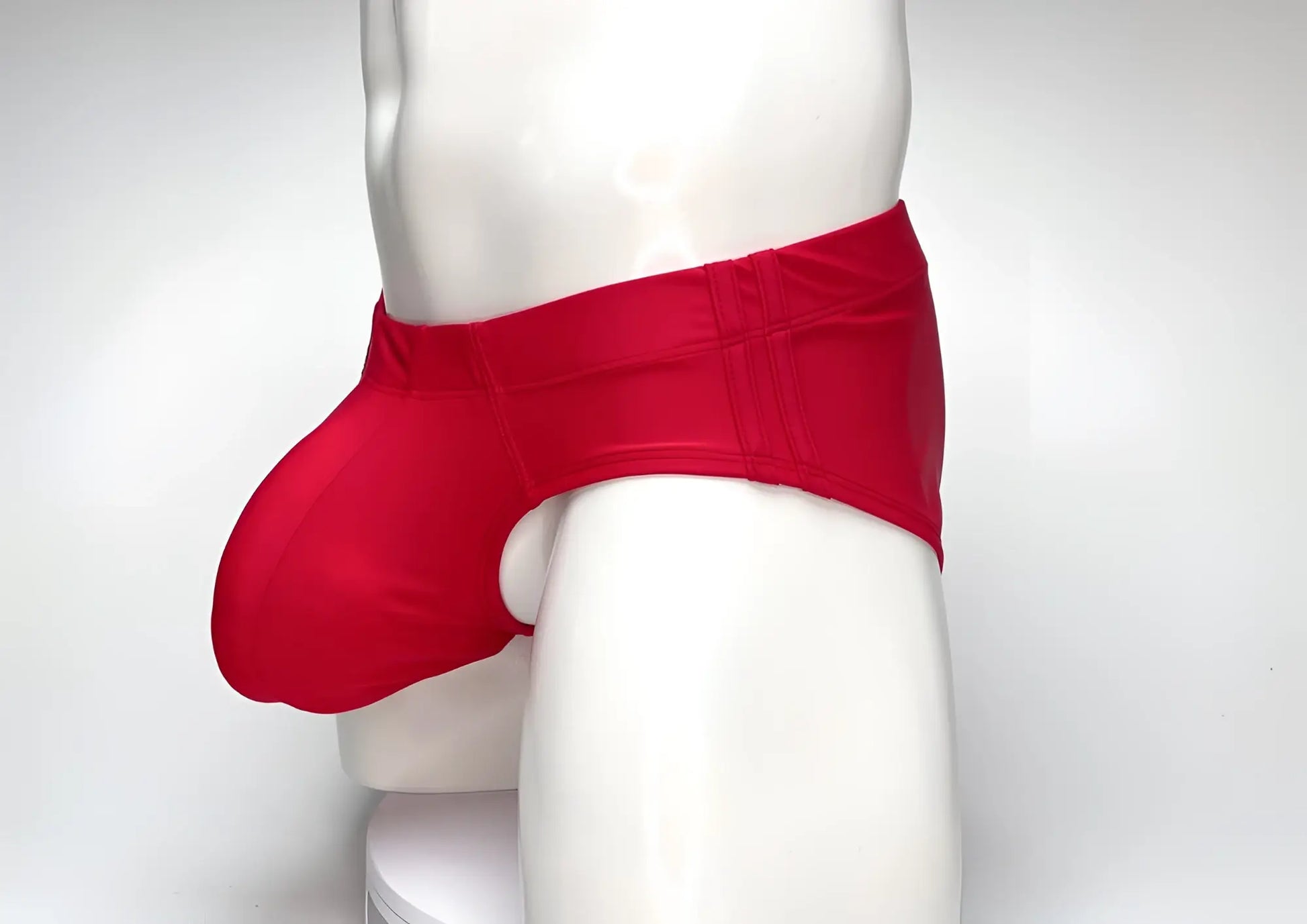Red WildmanT Big Boy pouch swim brief worn by a mannequin, featuring a contoured front pouch and wide side panels.