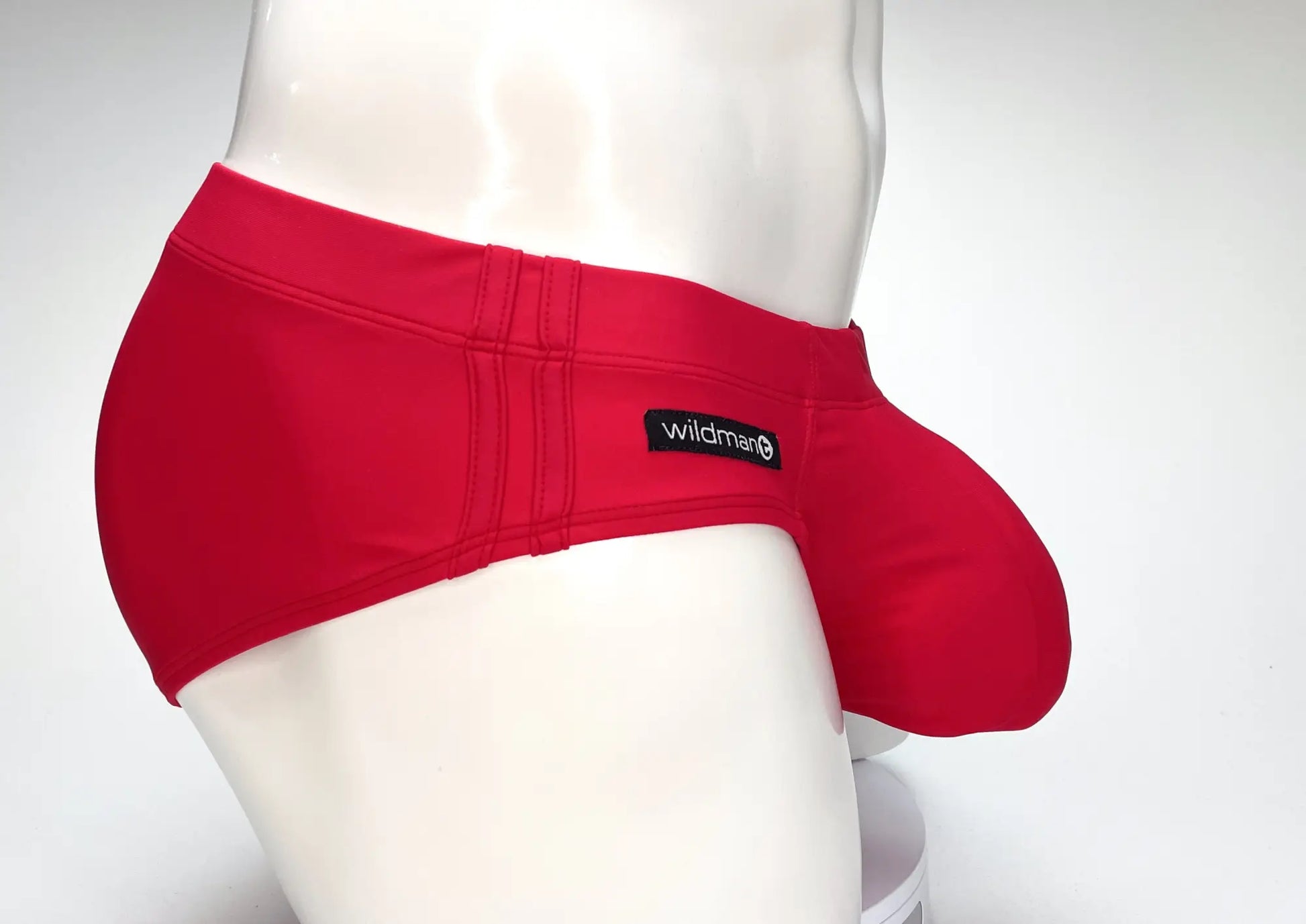 WildmanT big boy pouch swim brief in red with smooth form-fitting fabric and black wildman logo patch on waistband