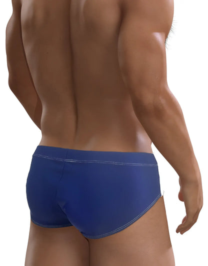 Rear view of a man wearing a royal blue WildmanT Big Boy Pouch swim brief with white contrast stitching.
