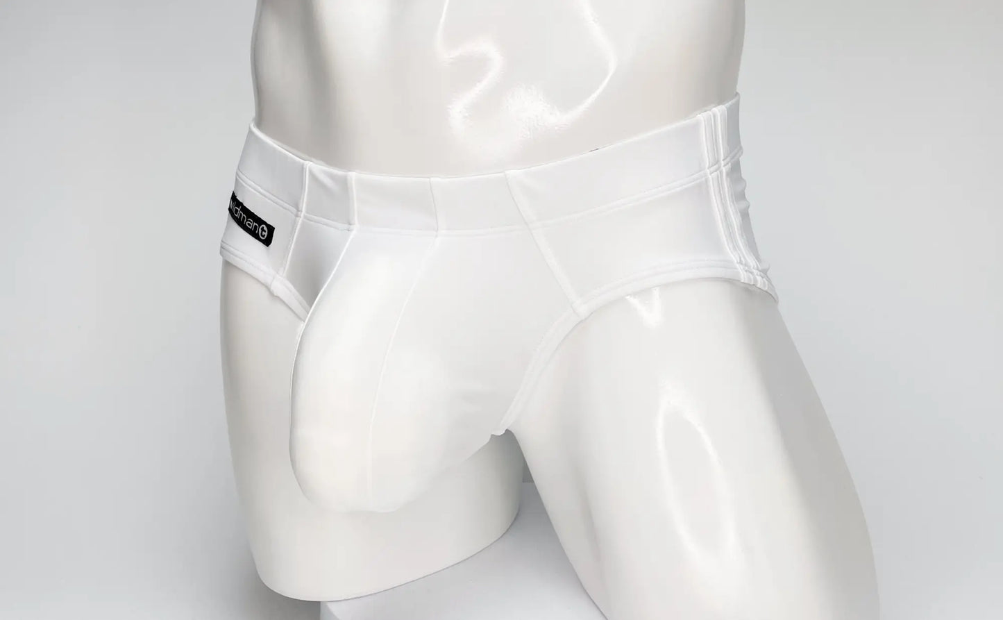 White glossy-finish men’s briefs with a sleek design and black brand tag on the waistband wildmant big boy pouch swim brief