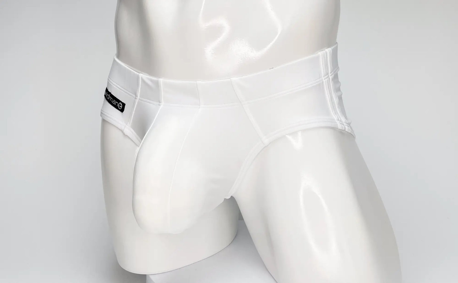 White glossy-finish men’s briefs with a sleek design and black brand tag on the waistband wildmant big boy pouch swim brief