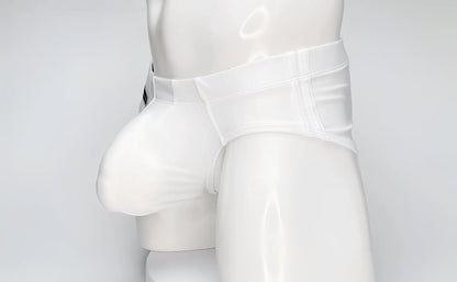 WildmanT white swim brief on a mannequin, featuring a large contoured front pouch and structured waistband.
