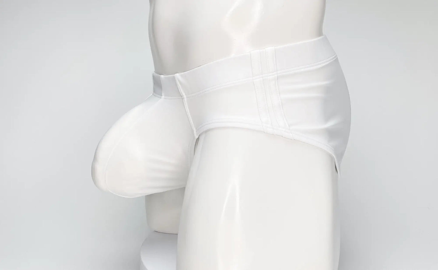 White glossy latex briefs by wildmant big boy pouch swim brief featuring a supportive contoured design
