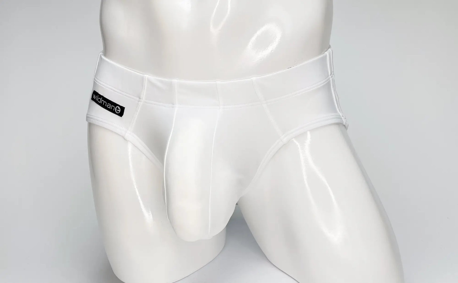 White glossy nylon swim briefs with black kidman label on waistband wildmant big boy pouch design