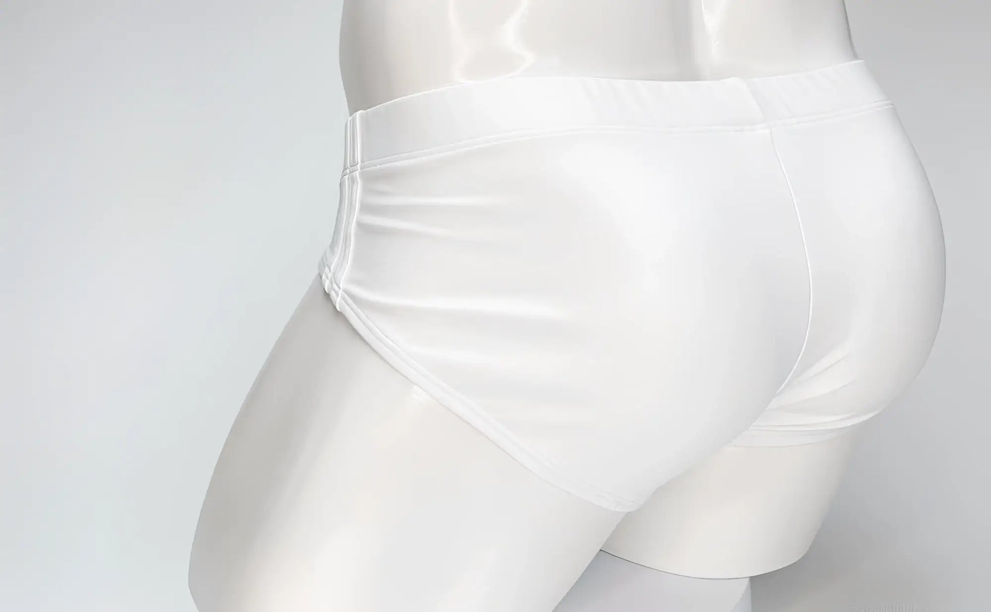 Back view of a plain white WildmanT Big Boy pouch swim brief on a white mannequin torso.