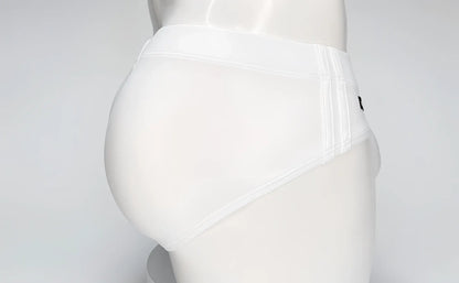 White WildmanT swim brief on a mannequin, featuring a contoured pouch design and side-stitched detailing.
