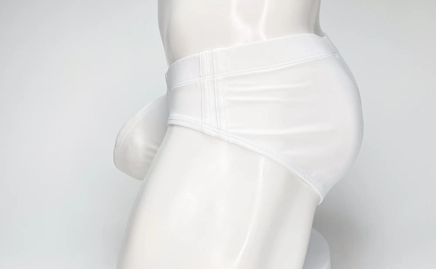 WildmanT big boy pouch swim brief in white with glossy smooth fabric and visible waistband stitching