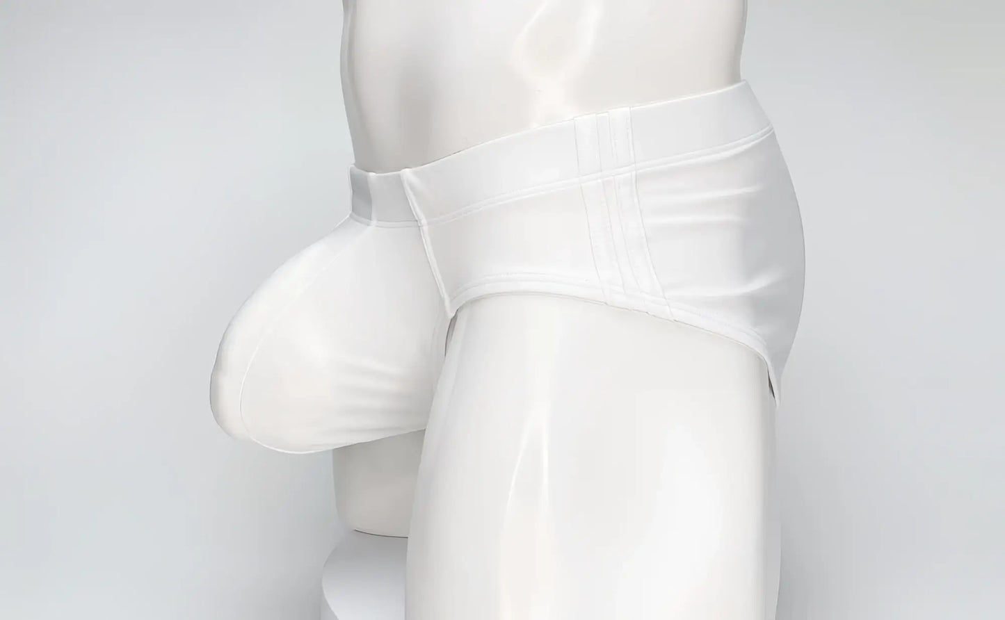 White WildmanT Big Boy pouch swim brief worn by a white mannequin, featuring a distinct, prominent front pouch design.