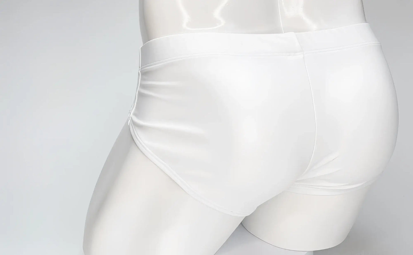 WildmanT white swim brief on a mannequin, featuring a snug fit with minimalist, sleek styling.