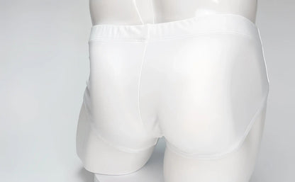 Back view of white WildmanT Big Boy Pouch swim brief on a mannequin against a plain light background.