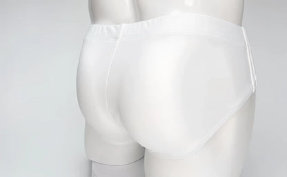 Back view of plain white WildmanT Big Boy swim brief on a mannequin, featuring a smooth, form-fitting design.