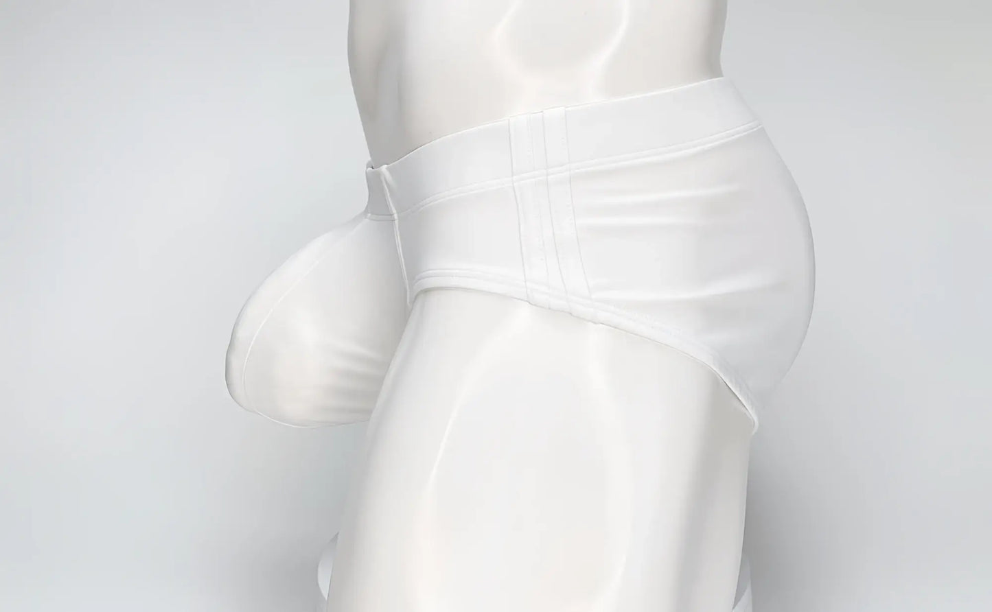 White WildmanT Big Boy Pouch swim brief with a prominent contoured front pouch on a mannequin torso.